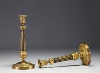 A pair of gilt bronze candlesticks decorated with vines and Doric columns, Empire period.