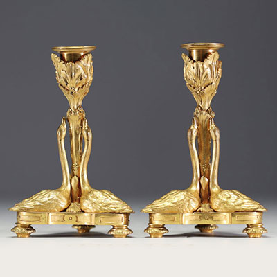 A rare pair of Louis XVI style ormolu candlesticks with swans, first half of the 19th century.