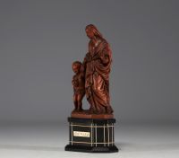 Vierge à l'enfant en buis sur socle en bois noirci, plaquette en os 