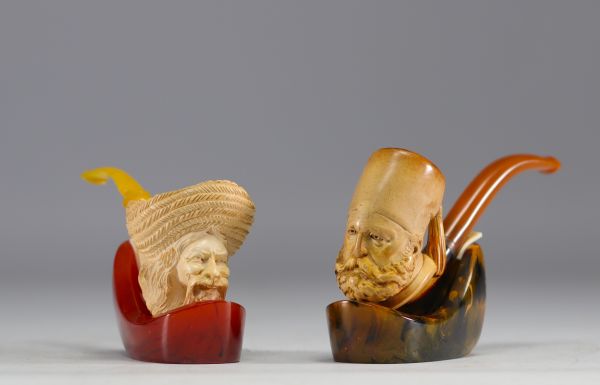 Set of two antique meerschaum pipes with figurative sheaths, 19th century.