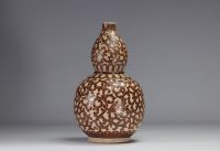 Indochina - ochre and green glazed ceramic gourd vase decorated with foliage, 1930