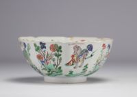 A porcelain bowl decorated with flowers and dogs with a mark under the piece, Kangxi period (1661-1722)