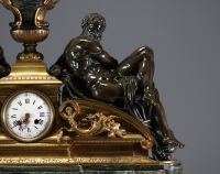 Imposing ormolu and patinated mantel clock decorated with antique figures, marble base, 19th century.