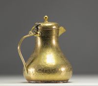 Persian coffee pot in chased brass with animal and figure motifs.