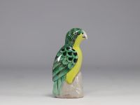 China - Green and yellow glazed ceramic parrot, perched on a rock, Qing period.