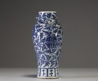 Chine - Vase en porcelaine blanc bleu à décor de fleurs et rinceaux feuillagées, chilong en relief sur l'épaulement, XIXème.