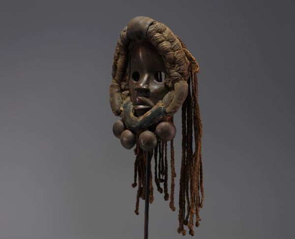 Africa - Dan mask in carved wood, braided ropes and bells, early 20th century