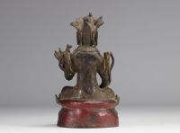 Statue of a traditional seated figure in bronze originating from China from the Ming period  (明朝)