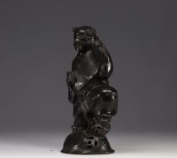 China - bronze sculpture of a young boy carrying a scroll.