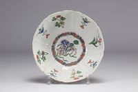 A porcelain bowl decorated with flowers and dogs with a mark under the piece, Kangxi period (1661-1722)