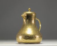 Persian coffee pot in chased brass with animal and figure motifs.