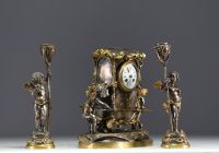 Auguste MOREAU (1834-1917) Gilt and silvered bronze clock and two candlesticks with putti decoration, signed Aug. Moreau, 19th century.