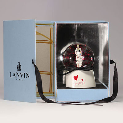 LAVIN PARIS musical glass snow globe depicting a young bride surrounded by flowers and glittering red snowflakes