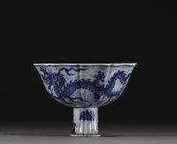 China - Bowl on foot in blue-white porcelain decorated with dragons in waves, Xuande mark.