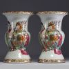 China - A pair of famille rose porcelain vases decorated with dignitaries, courtesans and poems, 19th century.