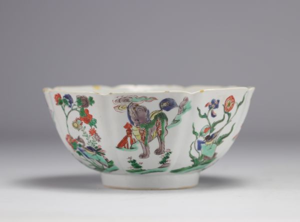 A porcelain bowl decorated with flowers and dogs with a mark under the piece, Kangxi period (1661-1722)