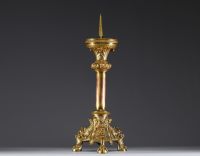 A large ormolu and chased bronze candlestick with a chalice decorated with a crown and leaves.