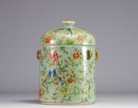 Covered pot in Famille Rose porcelain on a green background decorated with birds and flowers