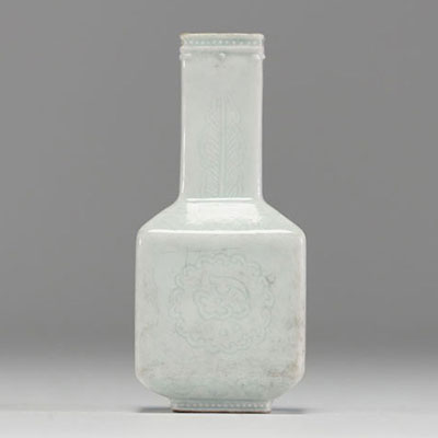 China - Small quadrangular vase in monochrome porcelain with floral decoration in relief, 19th century.