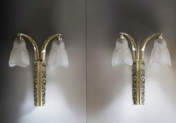 J. ROBERT (XIX-XX) Pair of Art Deco double sconces, pressed moulded glass globes and silvered bronze mounts with stylised decoration, unsigned.