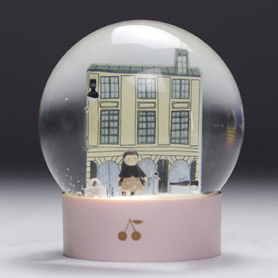 BONPOINT snow globe representing the famous Parisian shop on rue de Tournon with the Cerise doll and scooters