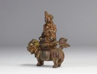 An ormolu Guanine sculpture resting on a lion from the Qing period (清朝)