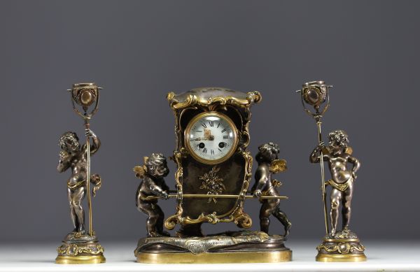 Auguste MOREAU (1834-1917) Gilt and silvered bronze clock and two candlesticks with putti decoration, signed Aug. Moreau, 19th century.