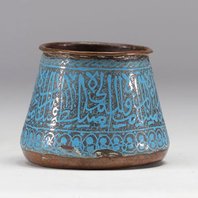 Islamic enamel bowl decorated with calligraphy on a blue background