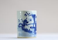 China - A white and blue porcelain brush pot decorated with dignitaries.