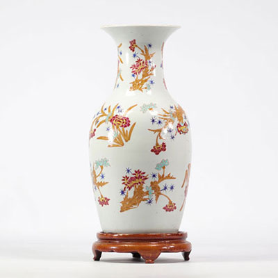 Famille rose porcelain vase with floral design on a white background