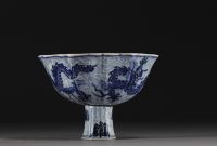 China - Bowl on foot in blue-white porcelain decorated with dragons in waves, Xuande mark.