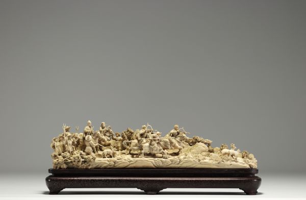 China - Ivory group carved in a tusk, depicting a hunt, silver-veined wooden base, circa 1920-30