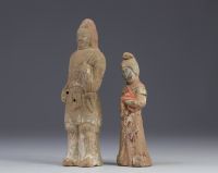 China - Two polychrome terracotta statues in the form of figures, from the Tang period (618-907).