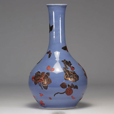 Chinese porcelain vase with relief decoration on a blue background