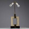 Jacques QUINET (1918-1992) attr. à Lampe de table en travertin et bronze patiné, base en métal laqué noir, vers 1960.