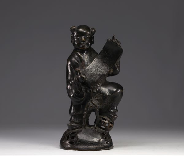 China - bronze sculpture of a young boy carrying a scroll.