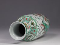 China - A green family porcelain vase decorated with trees and birds, early 20th century.