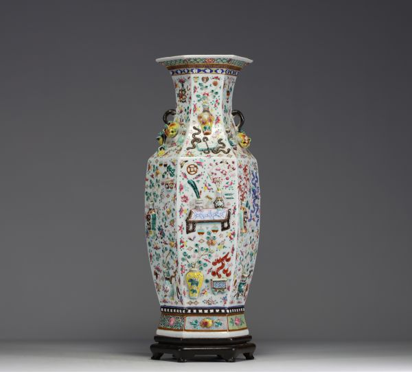 China - A rare pink family polychrome porcelain vase with relief decoration of domestic objects, fruit and floral motifs, hexagonal base, 19th century.