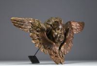 An 18th century carved wooden cherub with open wings.