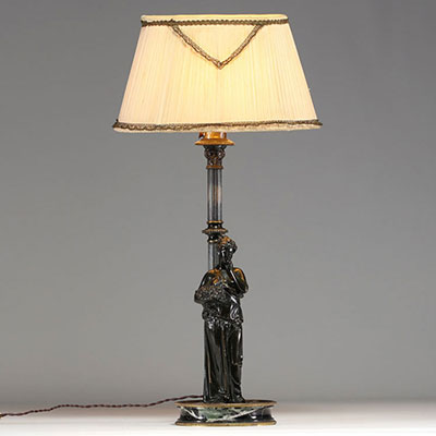 Bronze lamp depicting an antique woman leaning against a column, black marble base.