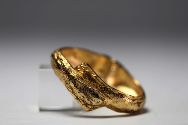 Yves SAINT LAURENT - Gilt metal bracelet, signed.