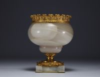 A Louis XVI gilt bronze and agate bowl supported by a cherub.