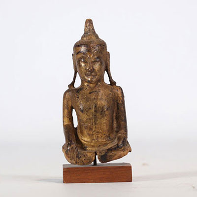 Fragment of a Buddha in gilded wood on a wooden base from Thailand