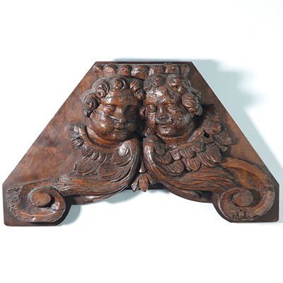 18th century wood paneling carved with angels' faces.