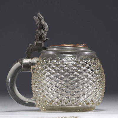 German diamond-point glass tankard with pewter lid featuring a figure.