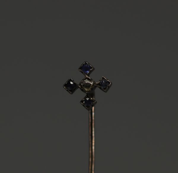 Gold tie pin, one rose-cut diamond and four sapphires.