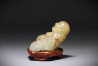 China - Green/brown jade Buddha on base.