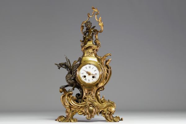 A 19th century ormolu and patinated clock decorated with a Putto and a winged dragon.