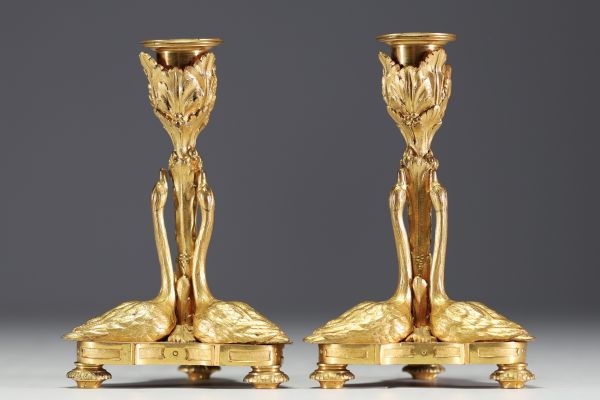 A rare pair of Louis XVI style ormolu candlesticks with swans, first half of the 19th century.e.