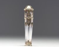 A rare solid silver and crystal perfume bottle decorated with musical instruments, foliage and flowers, the stopper representing a greyhound in vermeil, 19th century.